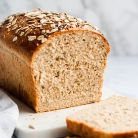 a loaf of homemade healthy sandwich bread with two slices cut out