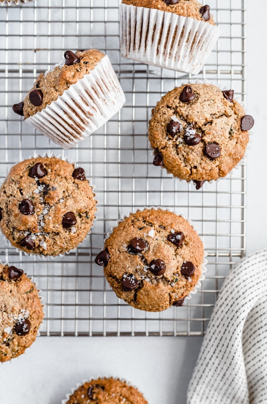 healthy zucchini muffins with chocolate chips on a wire rack