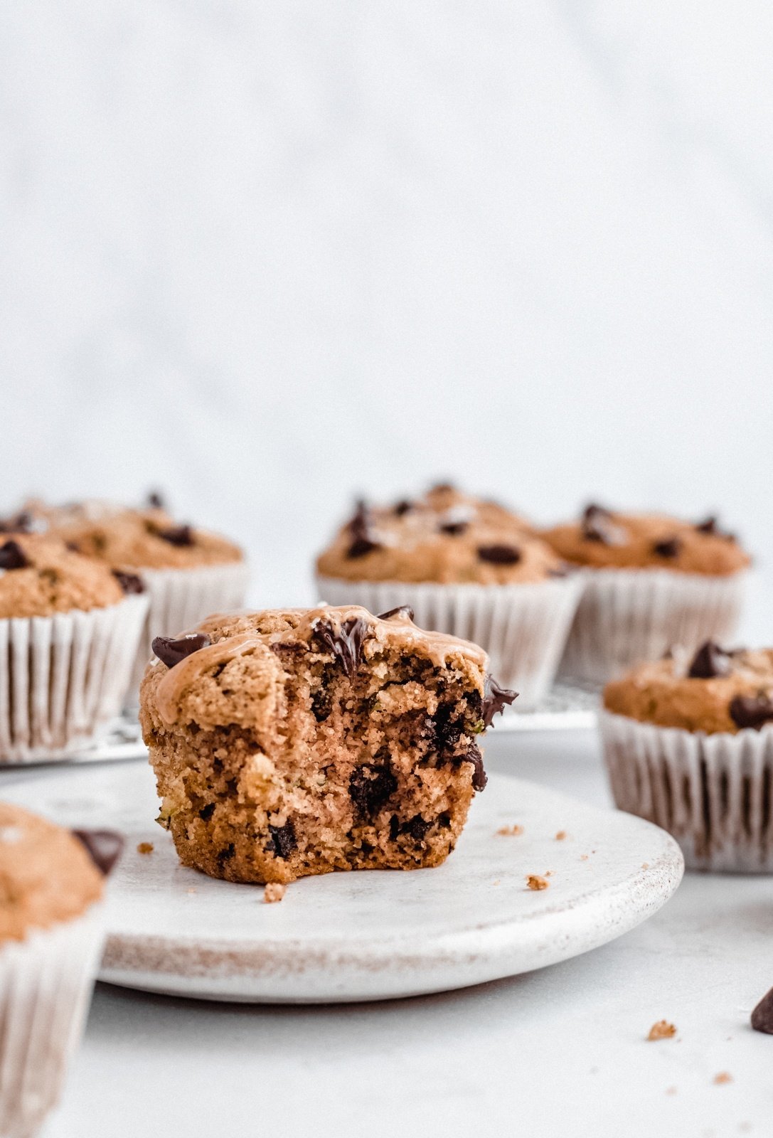 healthy zucchini muffin on a plate with a bite taken out