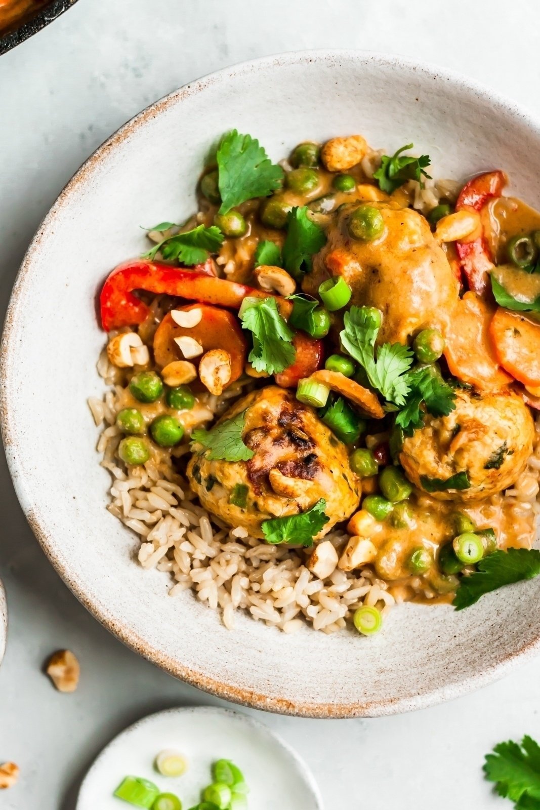 one pan ginger chicken meatballs with veggies and brown rice in a bowl 