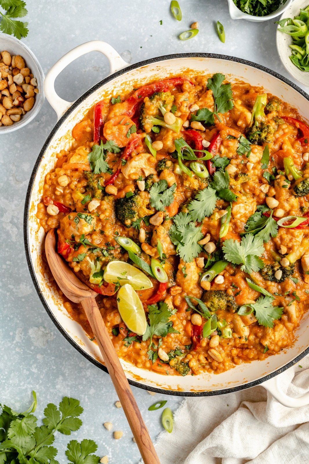 Thai-inspired chicken couscous recipe in a pot with a wooden spoon