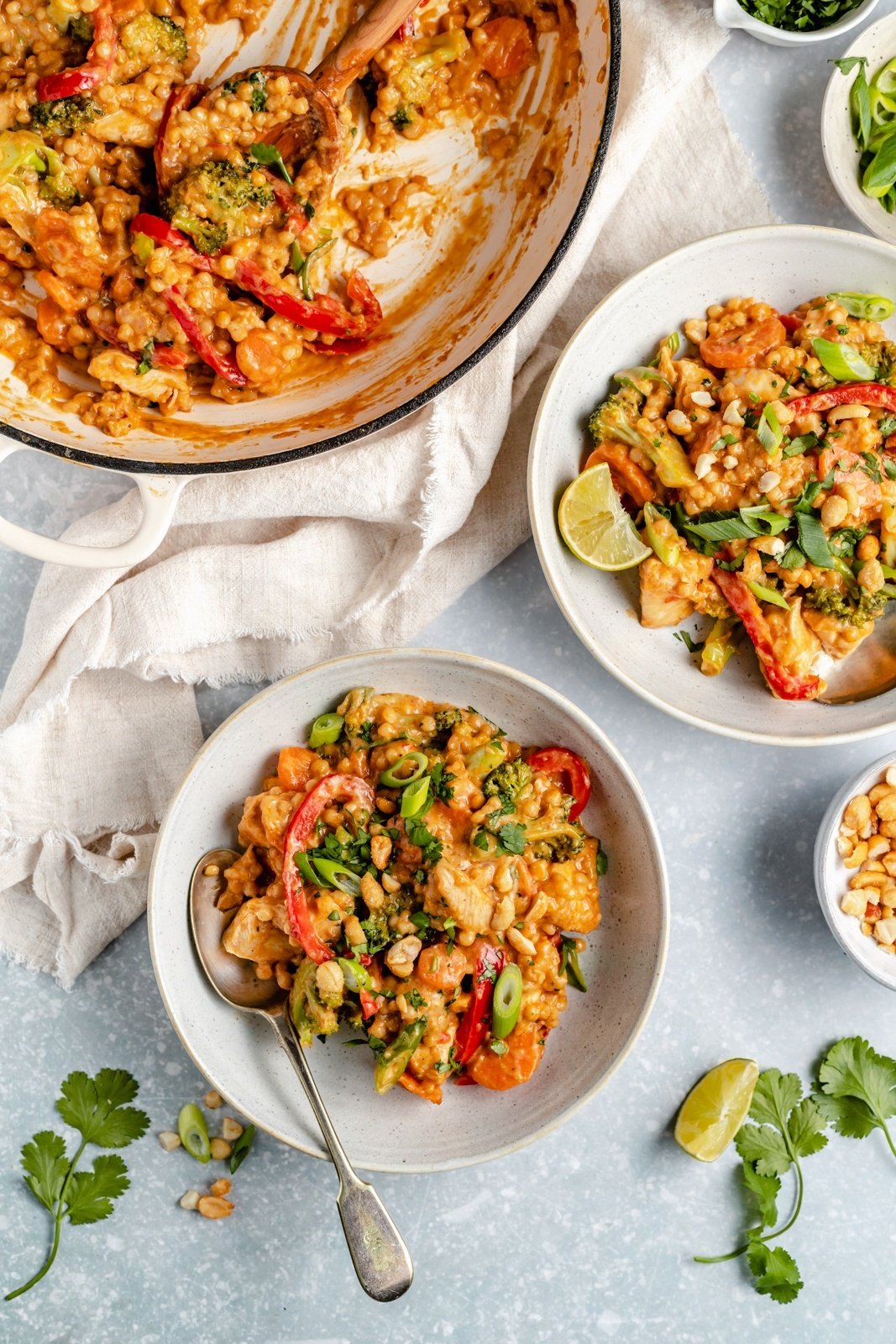 one pan chicken couscous with Thai flavors in a skillet and in two bowls