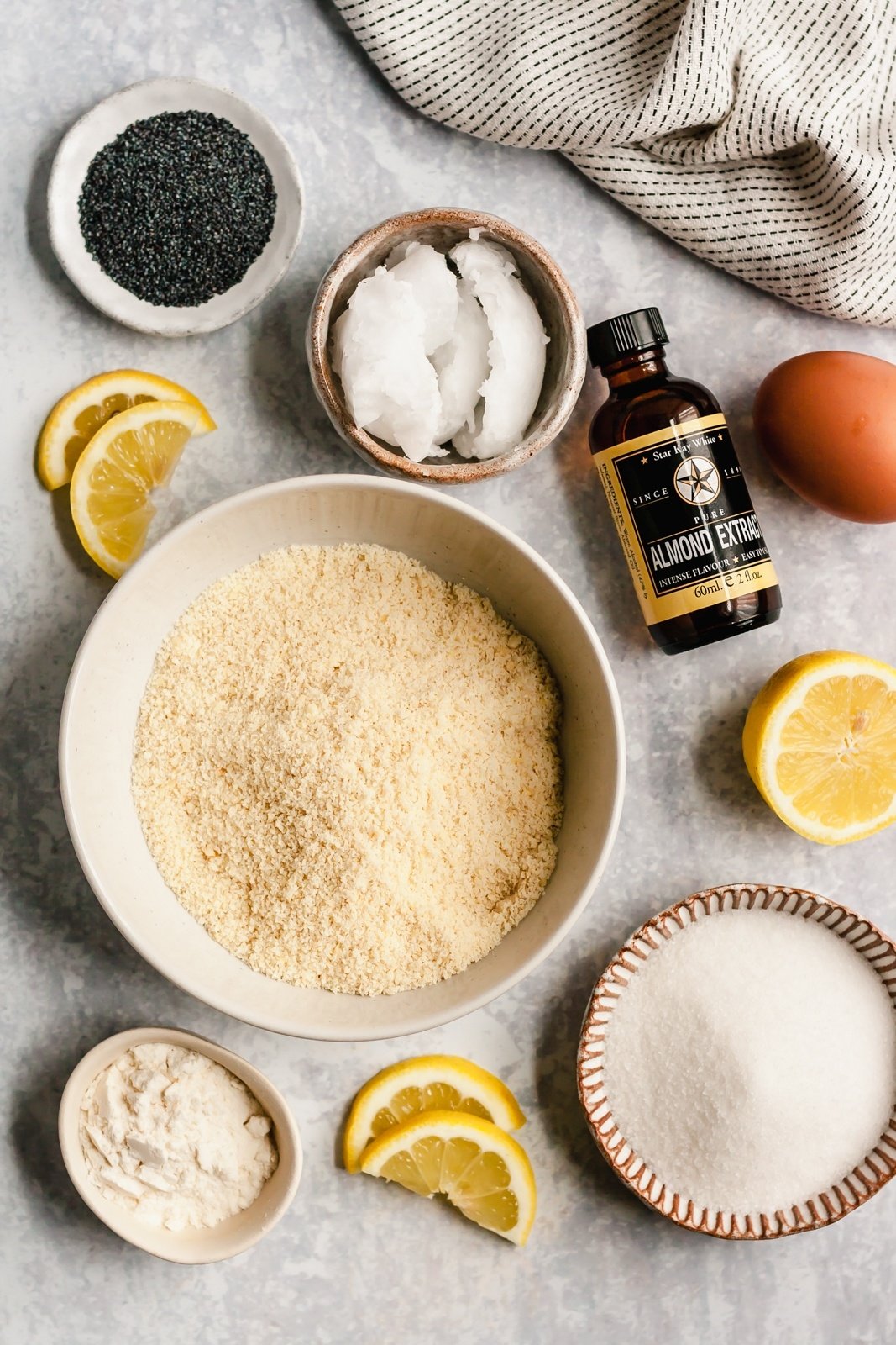 ingredients for paleo lemon poppy seed cookies on a grey board