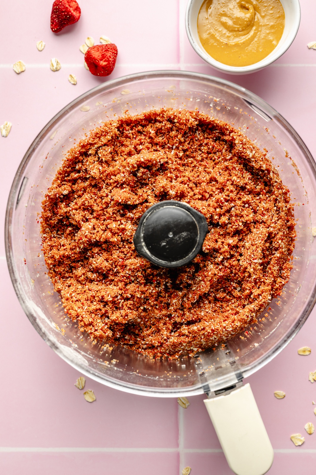 ingredients for PB&J energy bites blended in a food processor