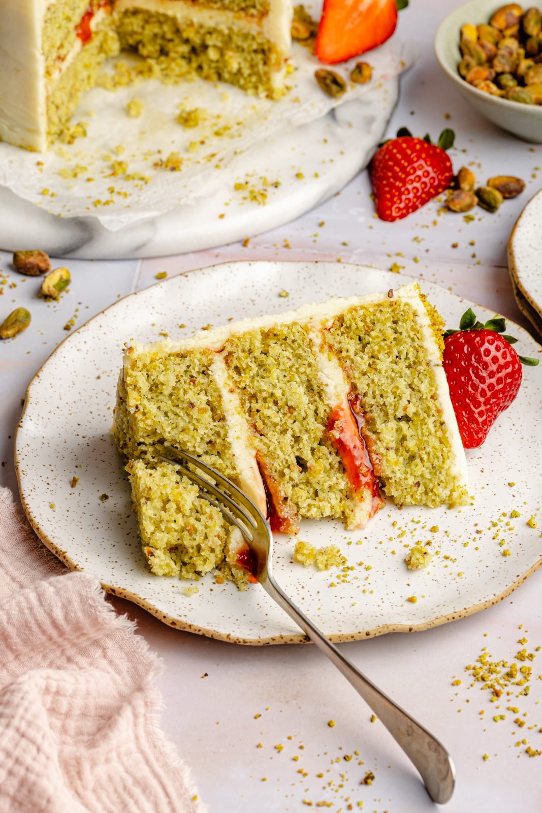 slice of lemon pistachio cake on a plate