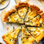 sun-dried tomato puff pastry quiche sliced on parchment paper