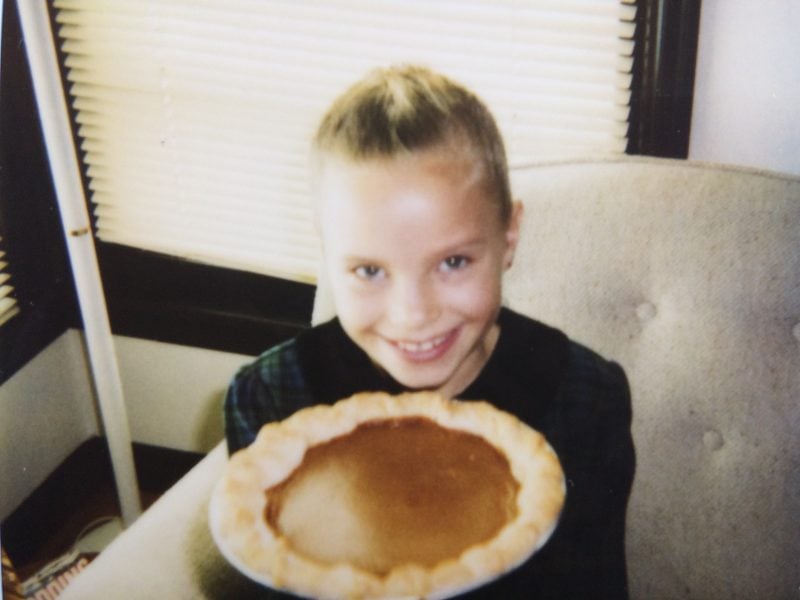 young monique holding a pumpkin pie