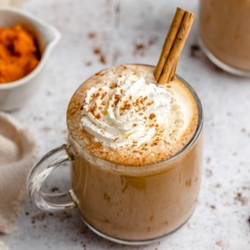 homemade pumpkin spice latte in a mug topped with whipped cream