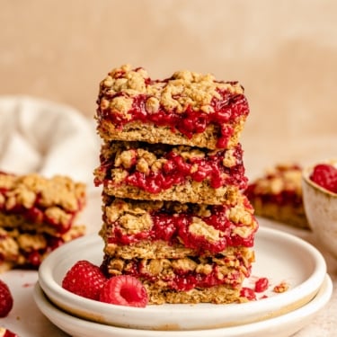 healthy raspberry bars in a stack on a plate