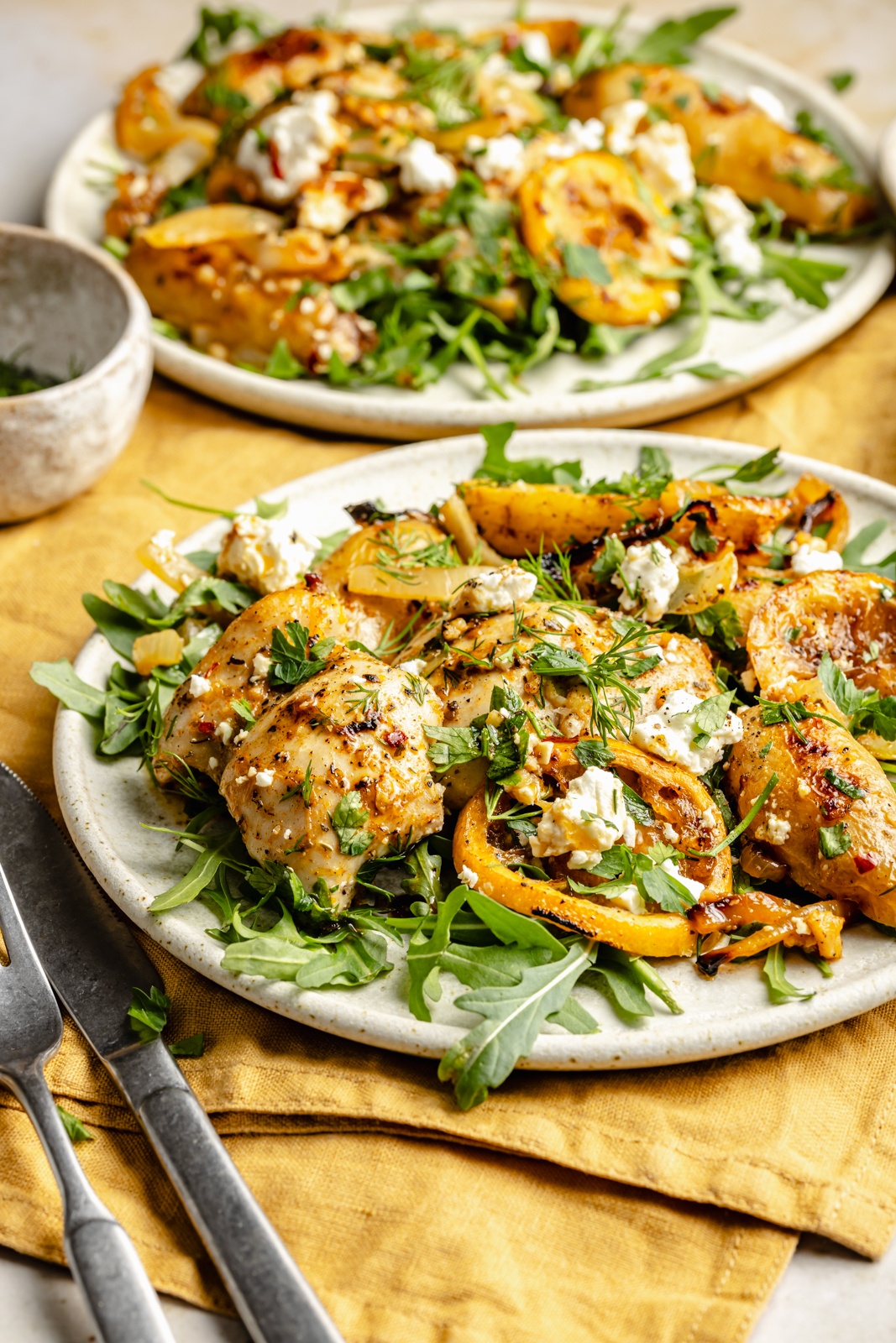 lemon chicken and potatoes on a plate with arugula