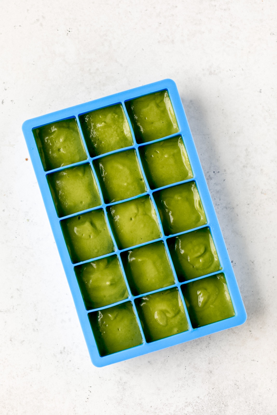 ice cube tray with green smoothie in it