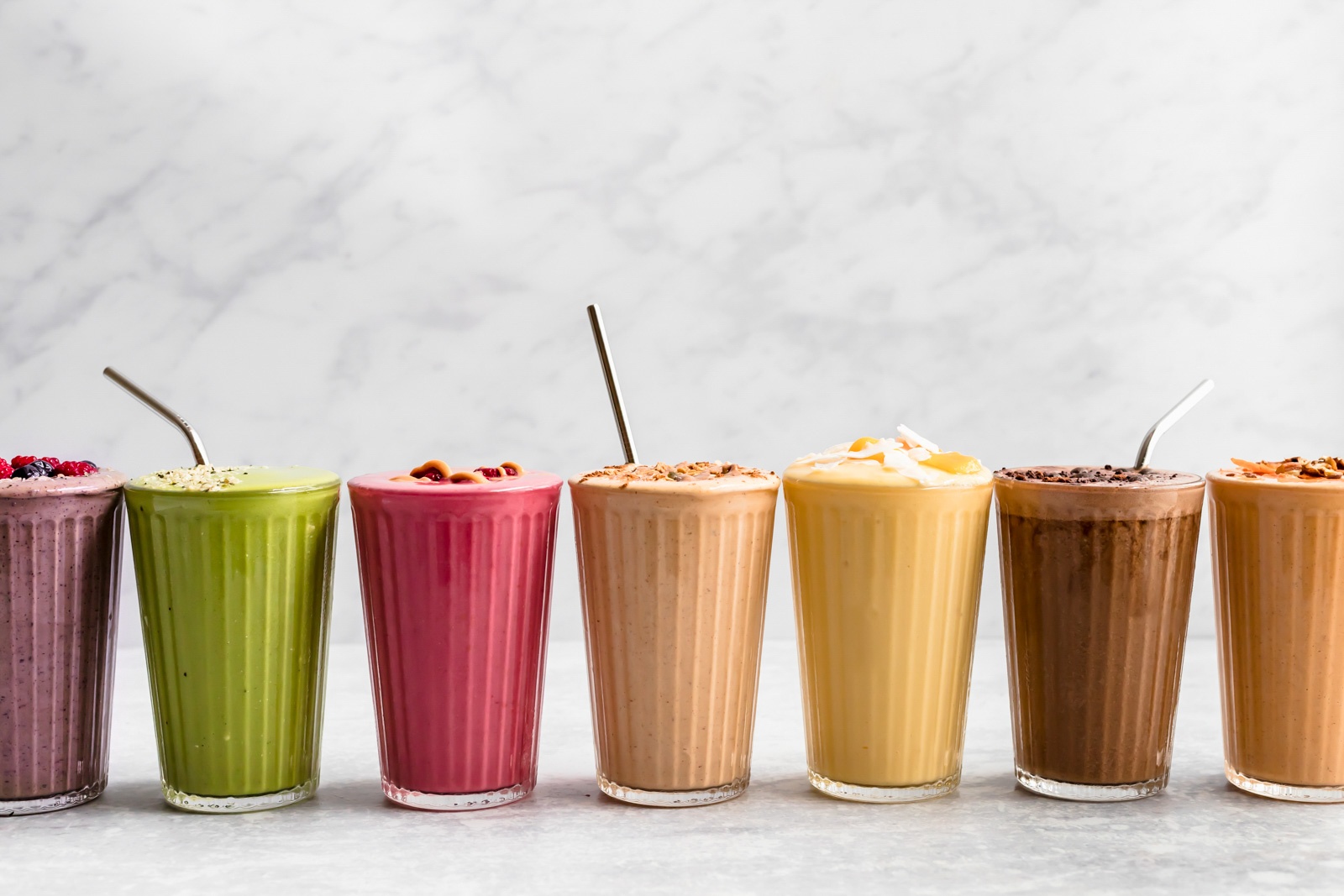 different colored smoothies all lined up