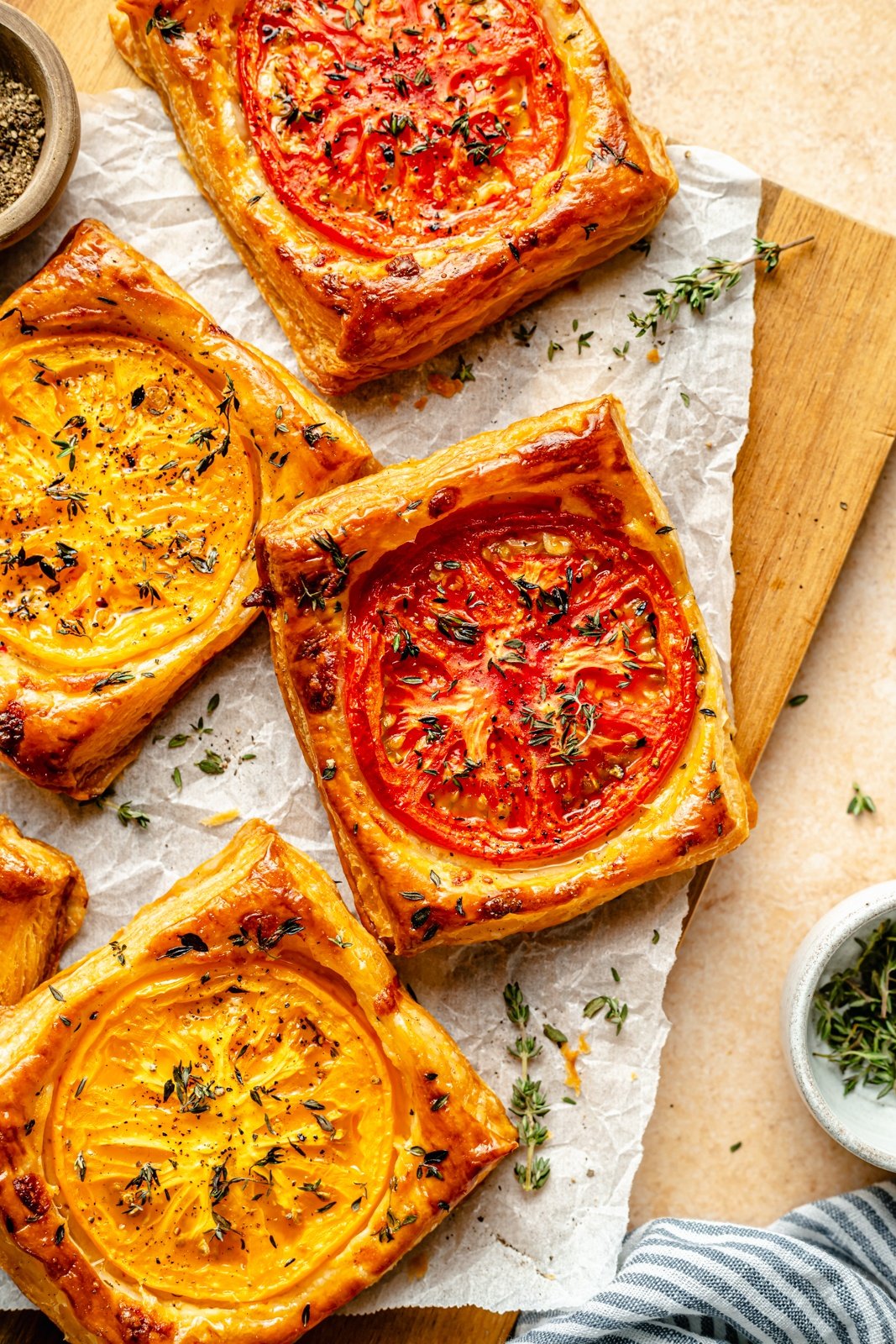 pizza tarts with heirloom tomato on a cutting board