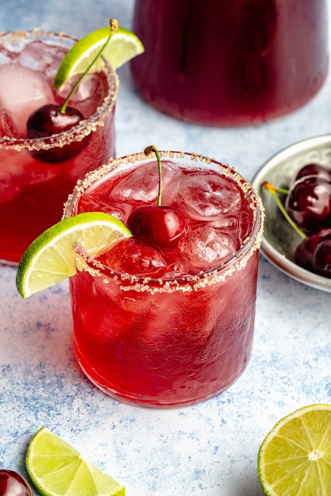 two cherry lime cocktails in glasses