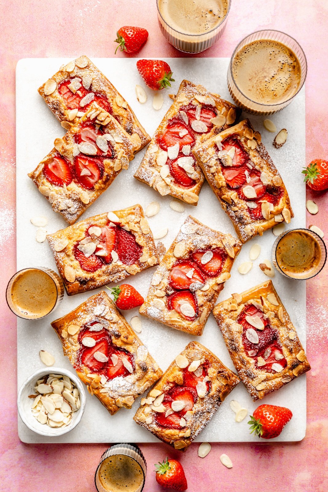 strawberry almond puff pastry tarts on a board