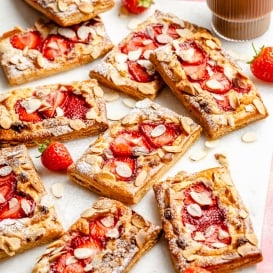 strawberry puff pastry tarts on a white board