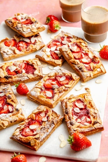 strawberry puff pastry tarts on a white board