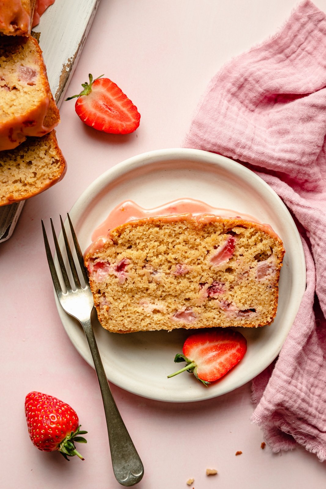 slice of healthy strawberry bread on a plate with a fork