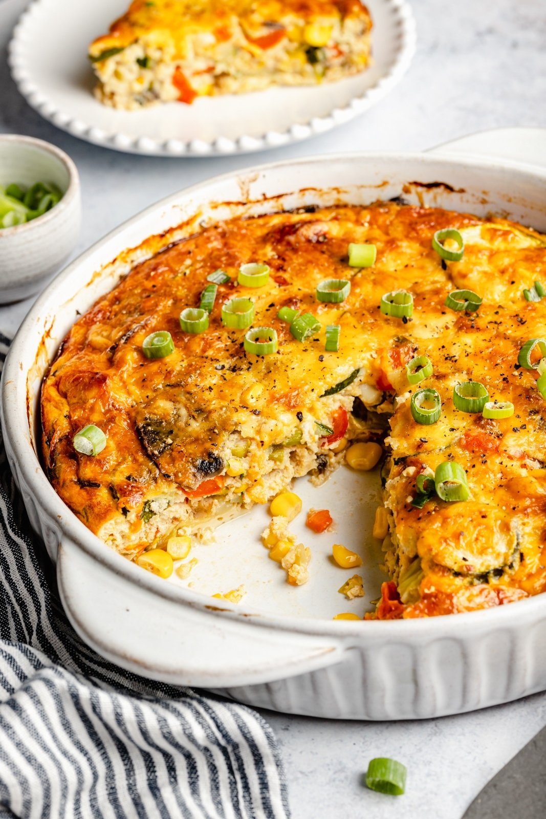 healthy zucchini pie in a baking pan with a slice cut out