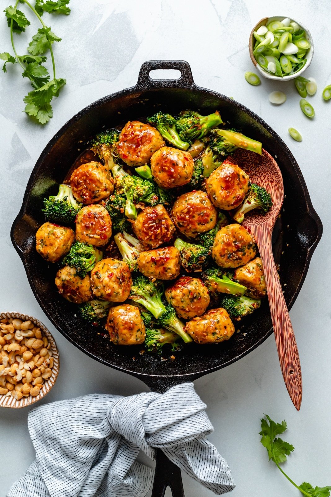 ginger sesame chicken meatballs and broccoli in a skillet