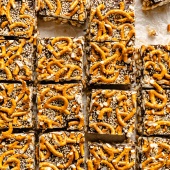 chocolate tahini rice krispie treats topped with pretzels