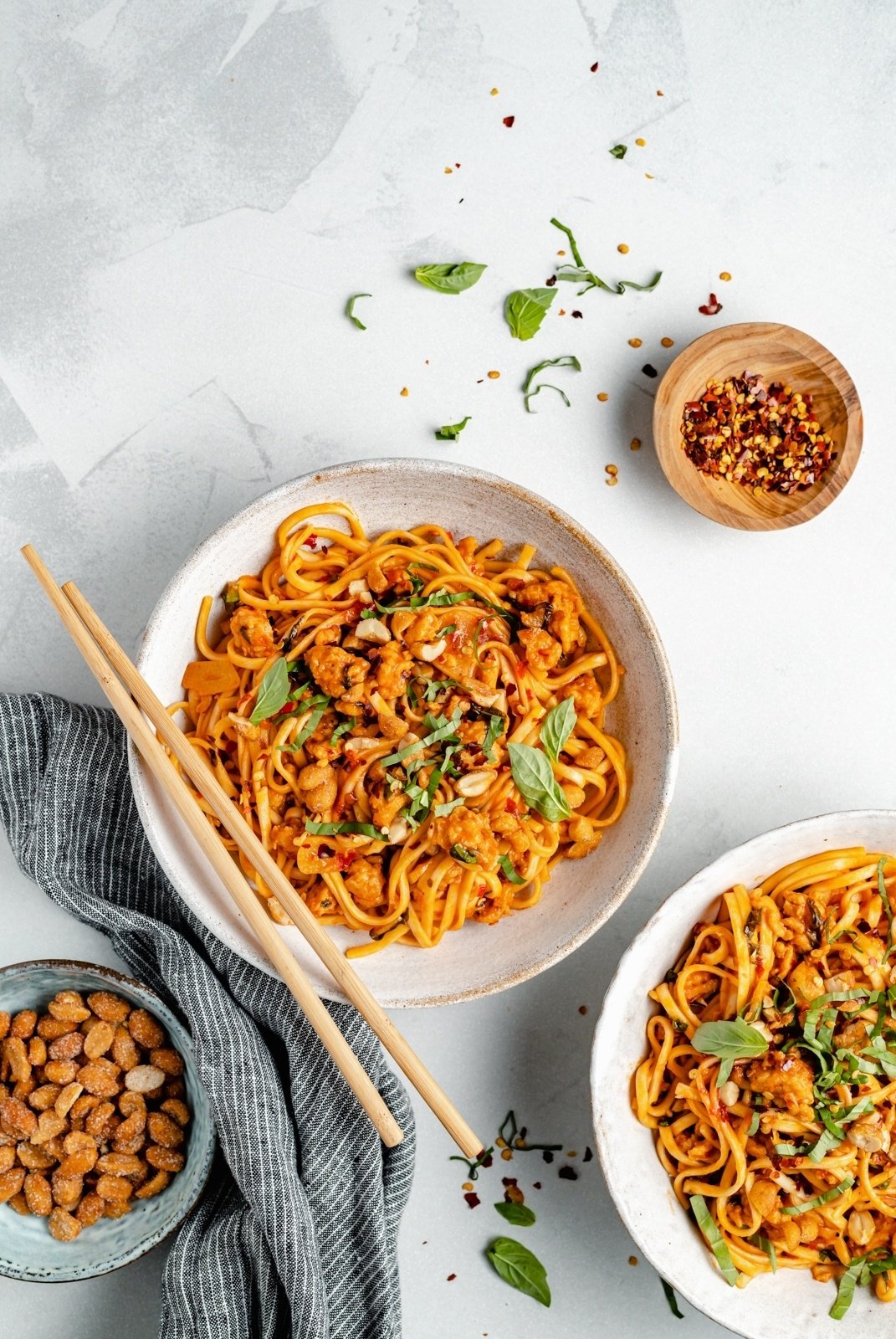 hot chili chicken noodles in bowls with chopsticks