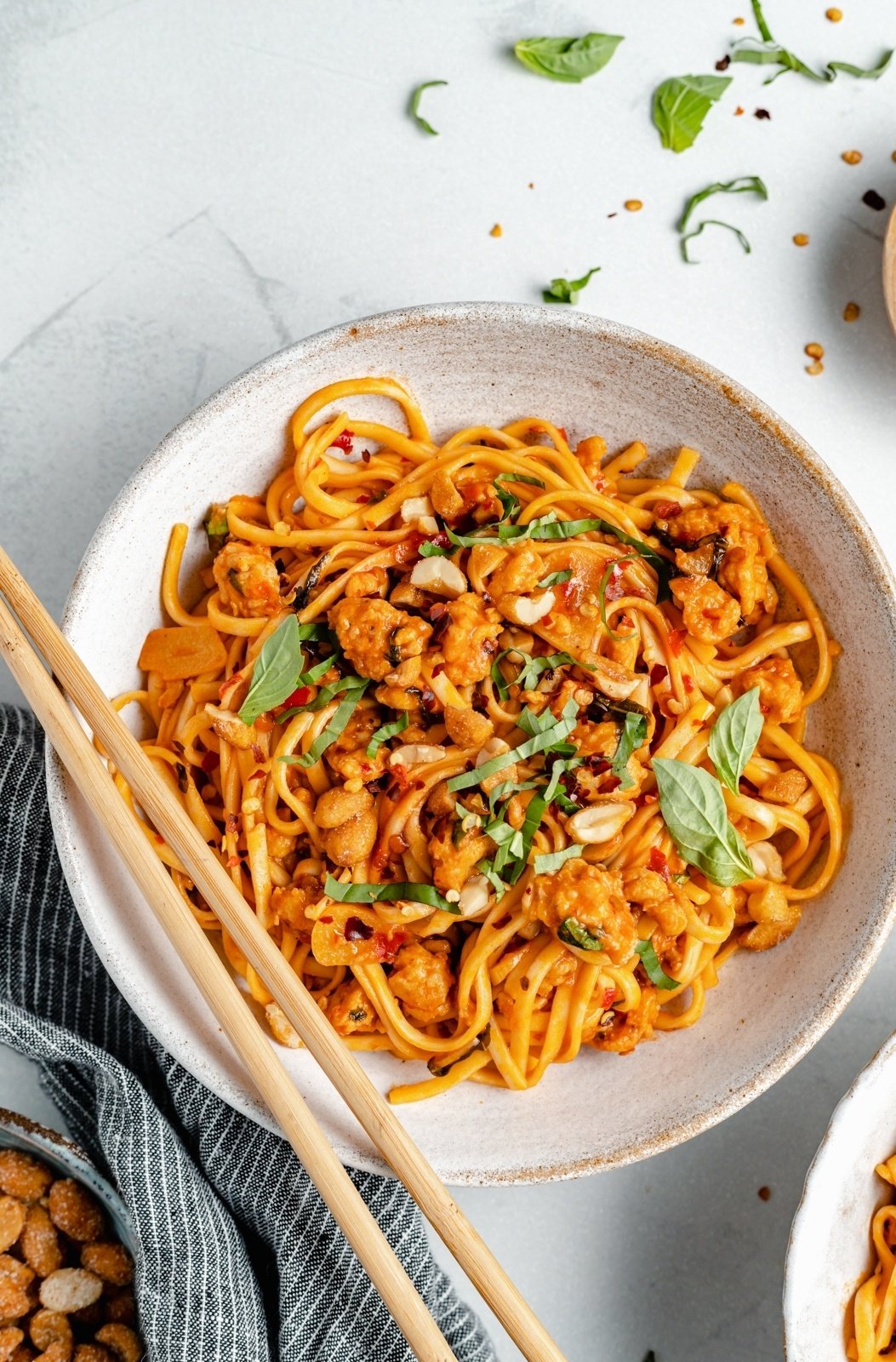 hot chicken chili noodles in a bowl with chopsticks