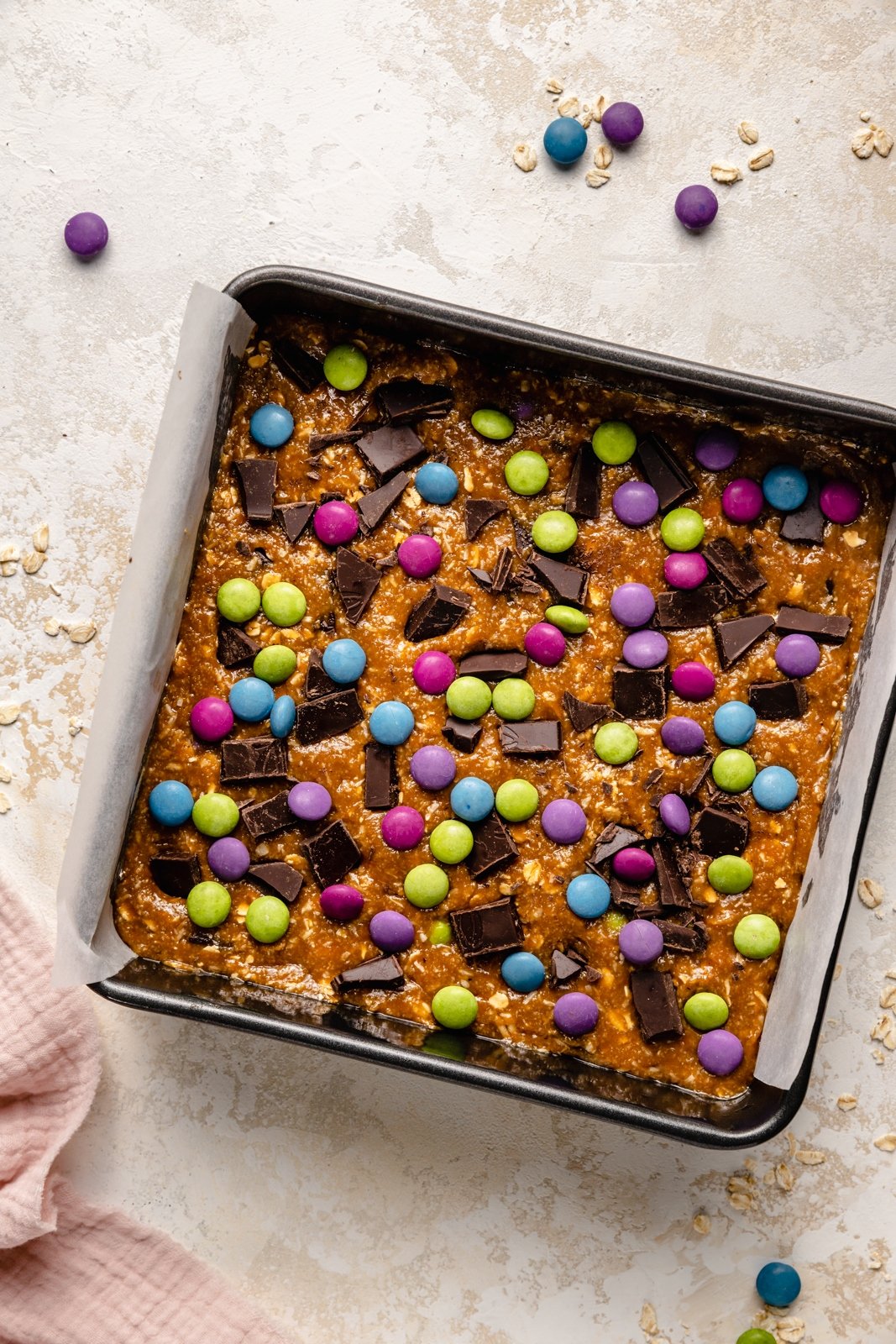 unbaked monster cookie bars in a pan