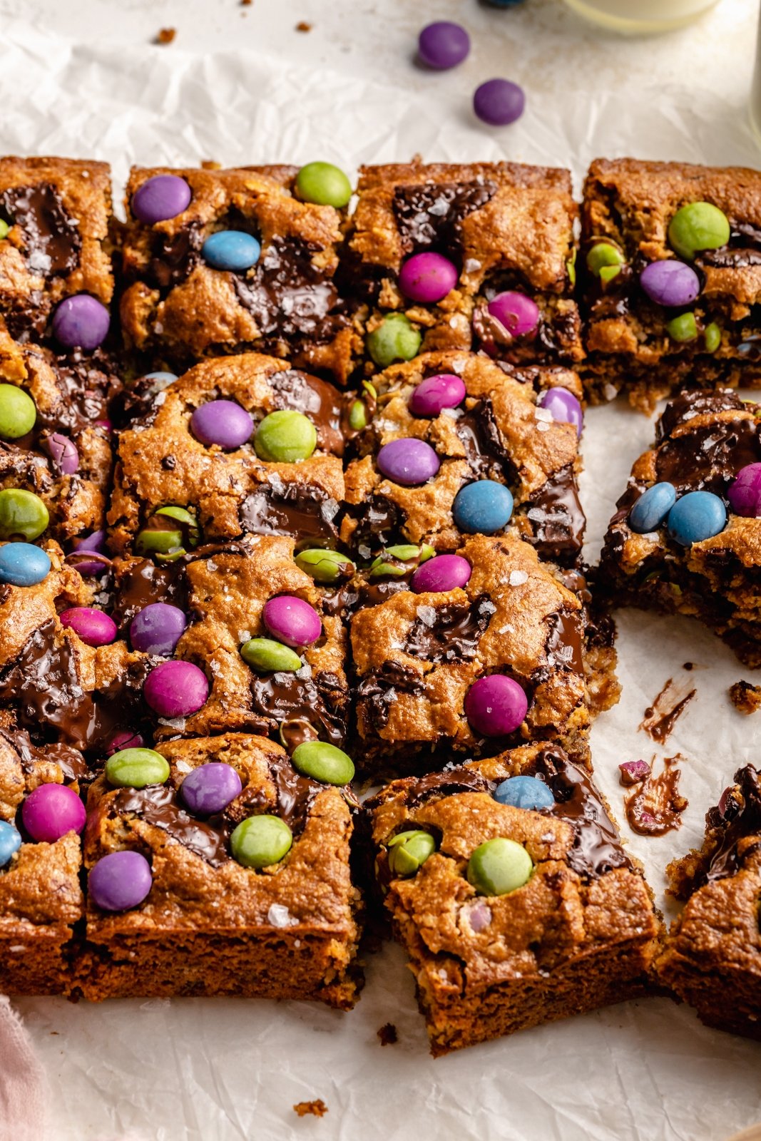 monster cookie bars without peanut butter sliced on parchment paper