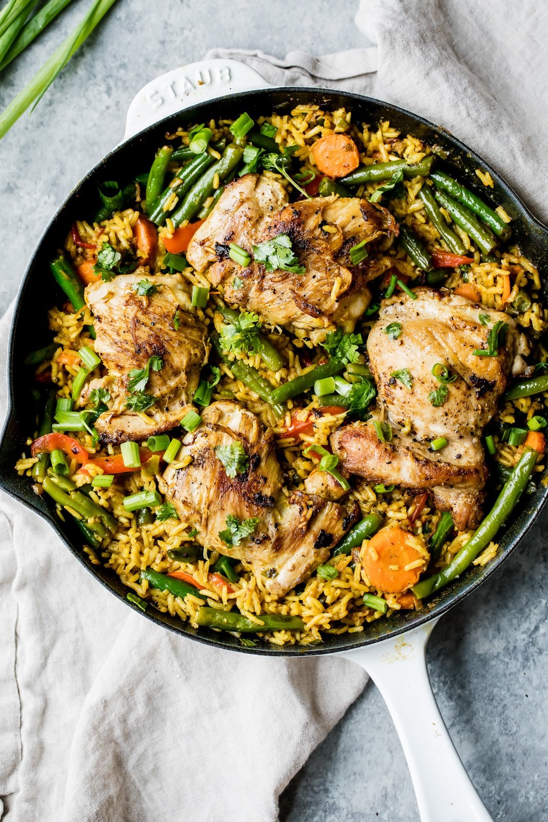 yellow curry chicken and rice in a skillet pan