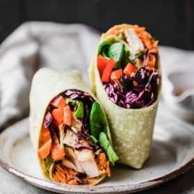 crunchy rainbow thai peanut chicken wrap on a plate