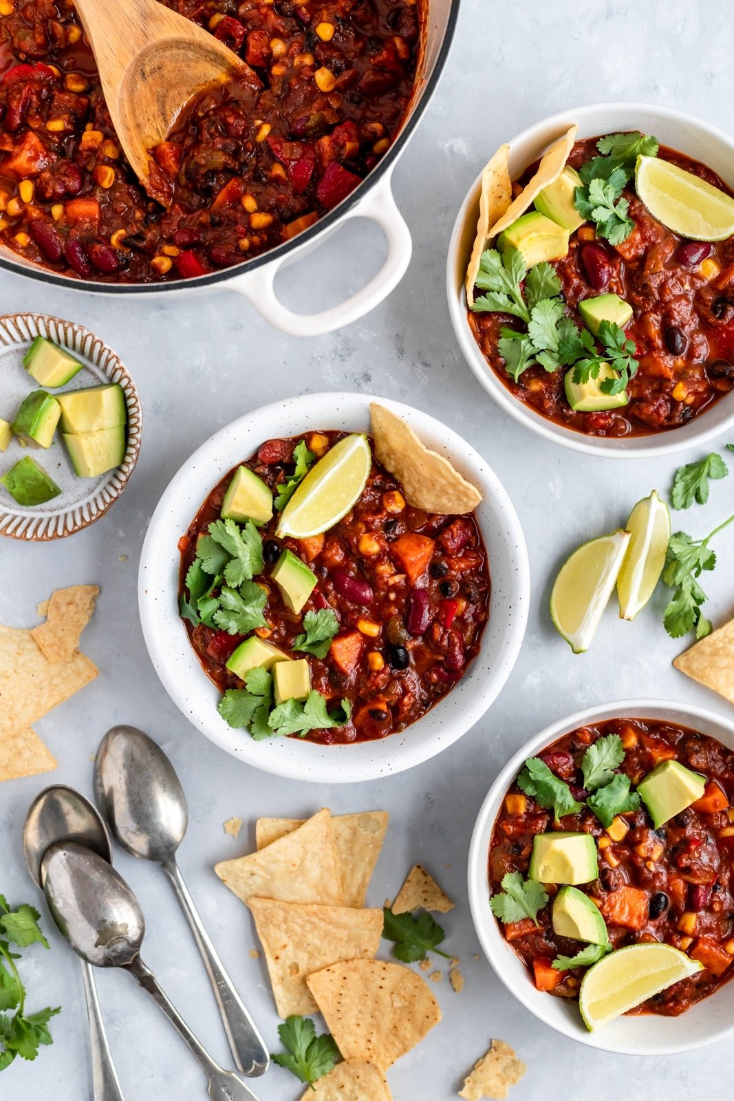 vegetarian chili in a pot and in three bowls