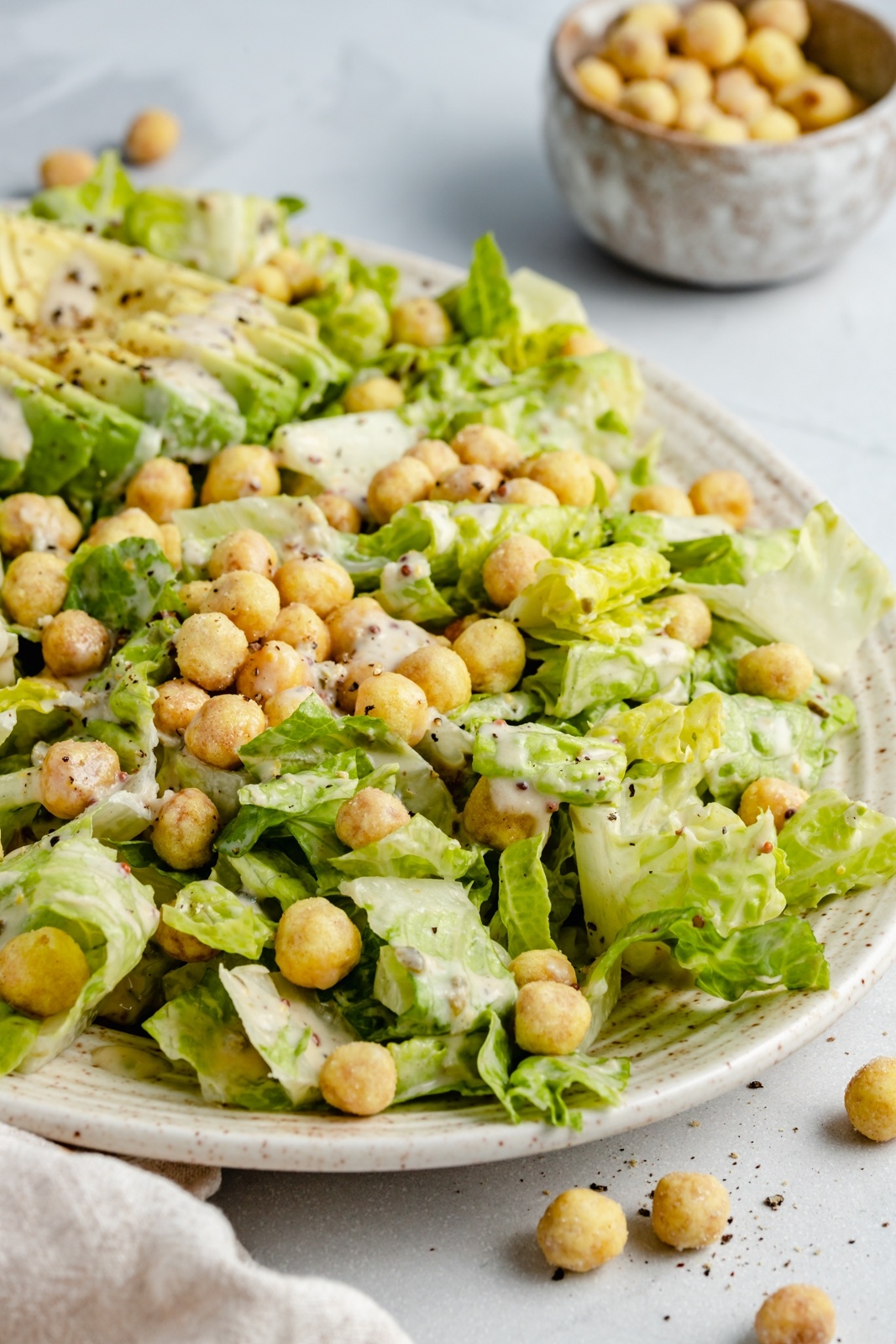 easy vegan caesar salad with chickpeas on a platter