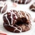 two chocolate peppermint cookies in a stack with a bite taken out